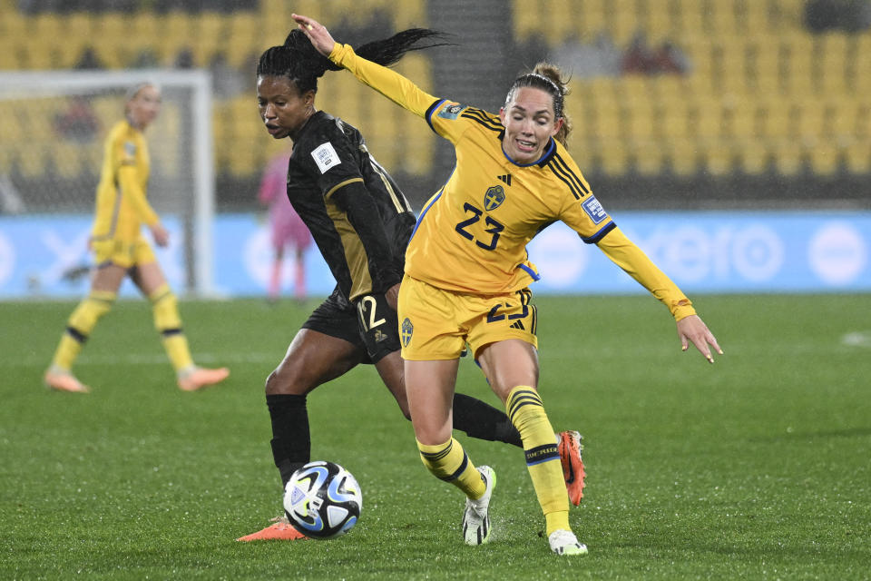 Sweden's Elin Rubensson, right, and South Africa's Jermaine Seoposenwe compete for the ball during the Women's World Cup Group G soccer match between Sweden and South Africa in Wellington, New Zealand, Sunday, July 23, 2023. (AP Photo/Andrew Cornaga)