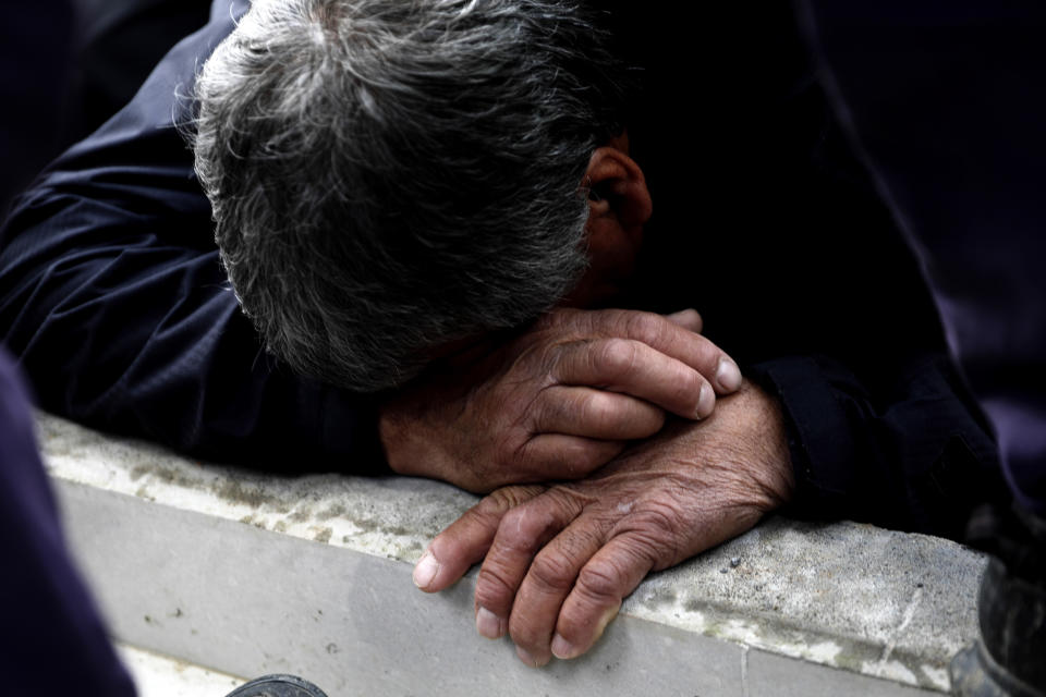 Carlos Cisterna grieves during the burial service for his son, slain police officer Carlos Cisterna, in Lebu, Chile, April 30, 2024. Armed assailants ambushed and killed three law enforcement officers including Cisterna, in southern Chile before setting their car on fire, authorities said. (AP Photo/Amilix Fornerod)