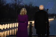 President-elect Joe Biden and his wife Jill Biden look out at lights during a COVID-19 memorial, with lights placed around the Lincoln Memorial Reflecting Pool, Tuesday, Jan. 19, 2021, in Washington. (AP Photo/Alex Brandon)