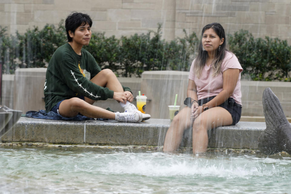 Students relax by Showalter Fountain on the Indiana University campus, Thursday, Oct. 14, 2021, in Bloomington, Ind. College communities such as Bloomington are exploring their options for contesting the results of the 2020 census, which they say do not accurately reflect how many people live there. (AP Photo/Darron Cummings)