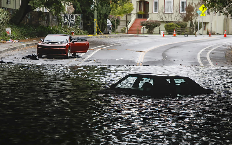 Cars sit stuck in a flooded underpass at Webster Street and 34th Street that has been underwater since this weekend’s storm in Oakland, Calif., on Jan. 4. <em>Salgu Wissmath/San Francisco Chronicle via AP</em>