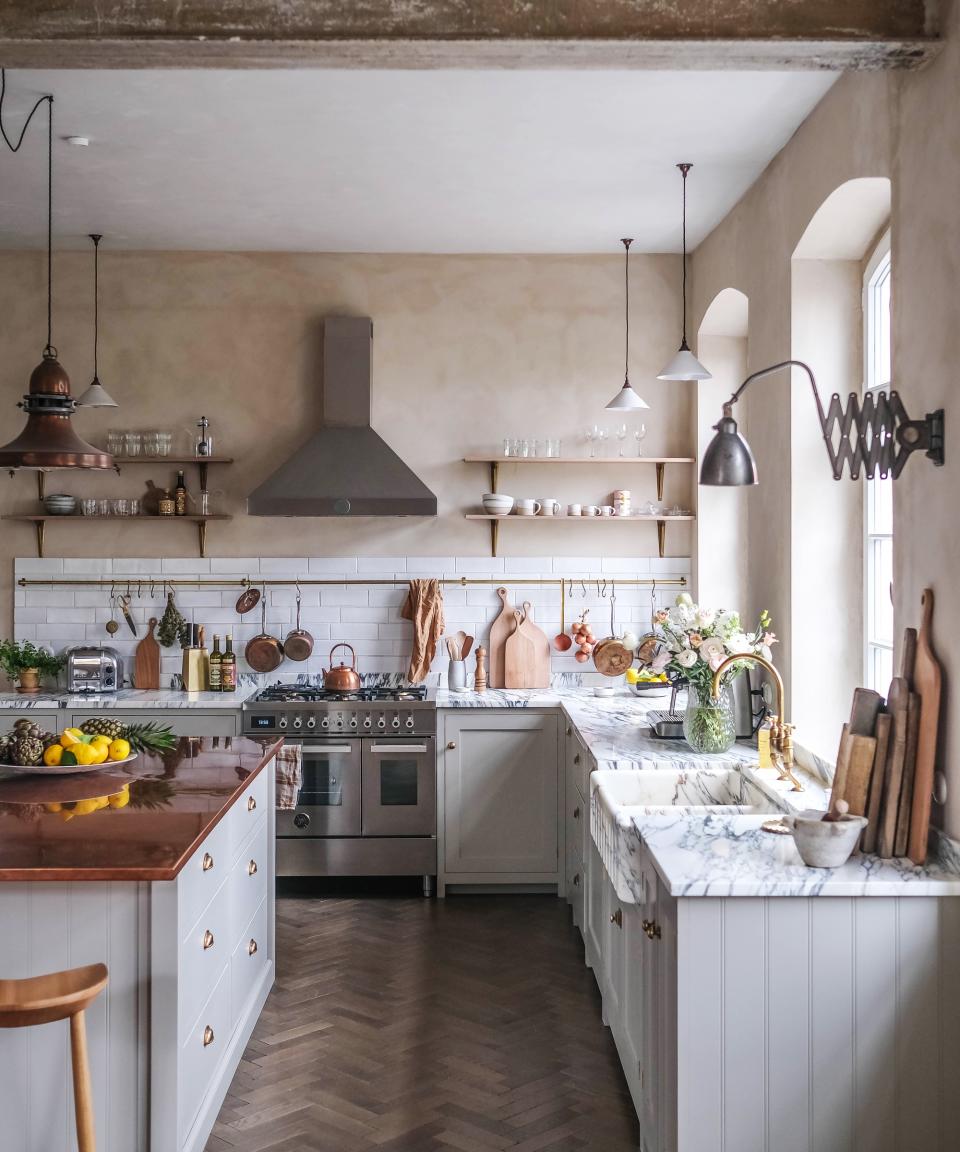 Rustic style kitchen with limewashed walls and painted cabinetry