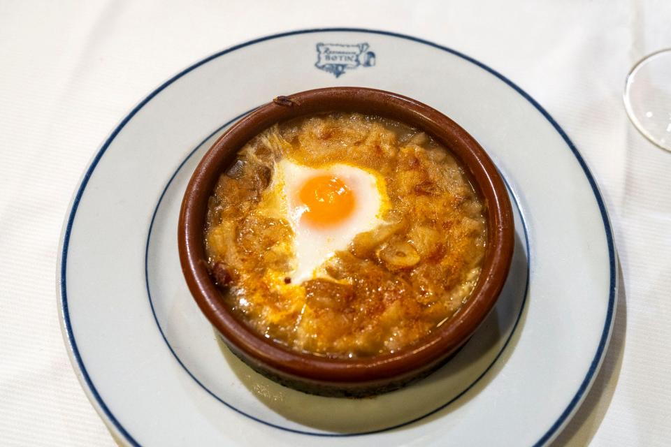 A bowl of soup sitting on a plate.