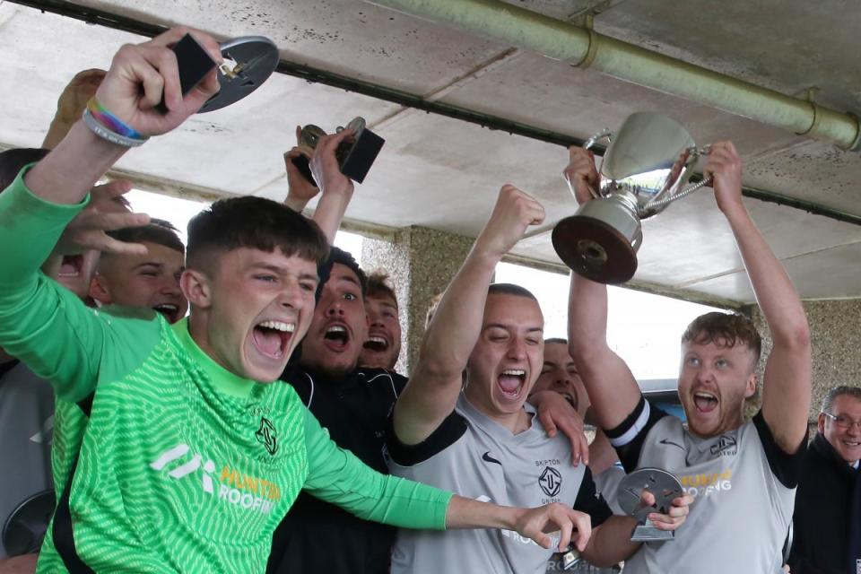 Skipton celebrate victory by lifting the trophy. Photo credit: Alex Daniel