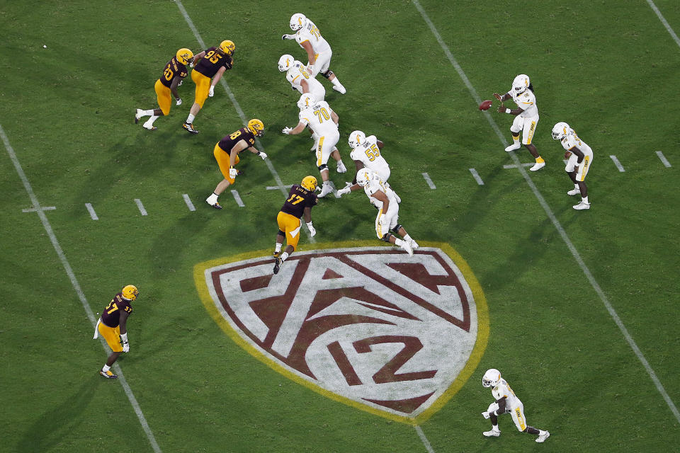 FILE - The Pac-12 logo is shown during the second half of an NCAA college football game between Arizona State and Kent State, in Tempe, Ariz. on Aug. 29, 2019. The Pac-12 will provide more access to players and coaches during broadcasts of football games next season, including in-game coaches interviews and halftime camera access. The changes will be implemented throughout football broadcasts on ESPN, Fox Sports and the Pac-12 Networks. (AP Photo/Ralph Freso, File)