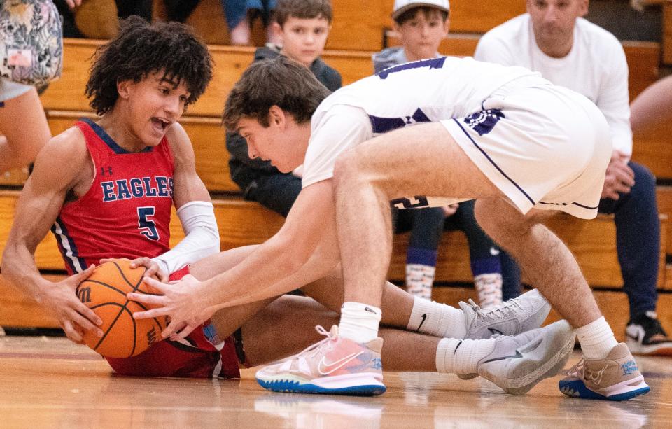 Brentwood Academy's Tyler Tanner (5) and Father Ryan's JD Fisch (12) tussle for the ball during their game at Father Ryan High School in Nashville, Tenn., Tuesday, Jan. 23, 2024.
