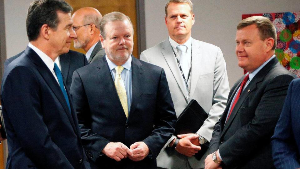 Governor Roy Cooper, left, Phil Berger, president pro tempore of the Senate, center, and Speaker of the House Tim Moore wait to walk to the podium before a press conference in Raleigh on Tuesday, May 1, 2018.