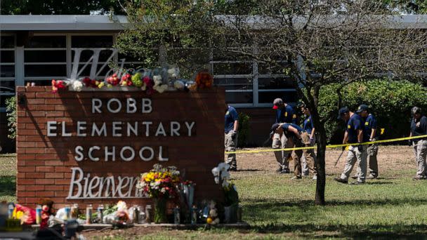 Investigators search for evidences outside Robb Elementary School in Uvalde, Texas, Wednesday, May 25, 2022. A gunman fatally shot 19 children and two teachers at the school the day before on May 24.  ((AP Photo/Jae C. Hong, File))