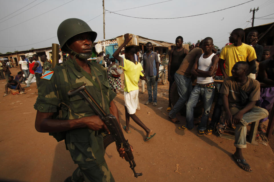 A soldier of the Democratic Republic of the Congo belonging to an African peacekeeping force, patrols on the streets of Bangui February 12, 2014. REUTERS/Luc Gnago (CENTRAL AFRICAN REPUBLIC - Tags: POLITICS CIVIL UNREST)