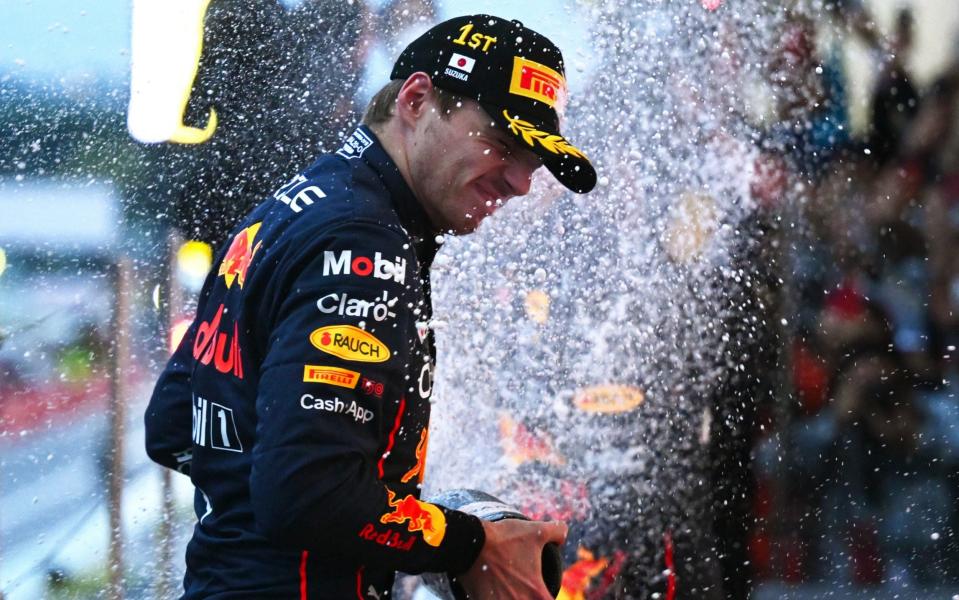 Race winner and 2022 F1 World Drivers Champion Max Verstappen of the Netherlands and Oracle Red Bull Racing celebrates on the podium during the F1 Grand Prix of Japan at Suzuka International Racing Course on October 09, 2022 in Suzuka, Japan - Getty Images