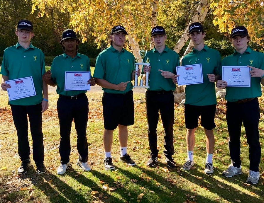 Members of the Tantasqua boys' golf team pose with the SWCL Championship trophy after taking the team title on Tuesday at Leicester Country Club.