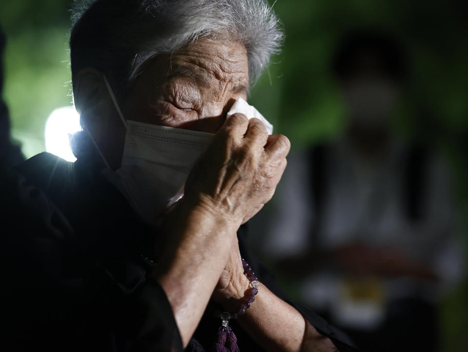 A visitor prays in front of the cenotaph dedicated to the victims of the atomic bombing at the Hiroshima Peace Memorial Park in Hiroshima, western Japan Saturday, Aug. 6, 2022. Hiroshima on Saturday marked the 77th anniversary of the world's first atomic bombing of the city. (Kyodo News via AP)