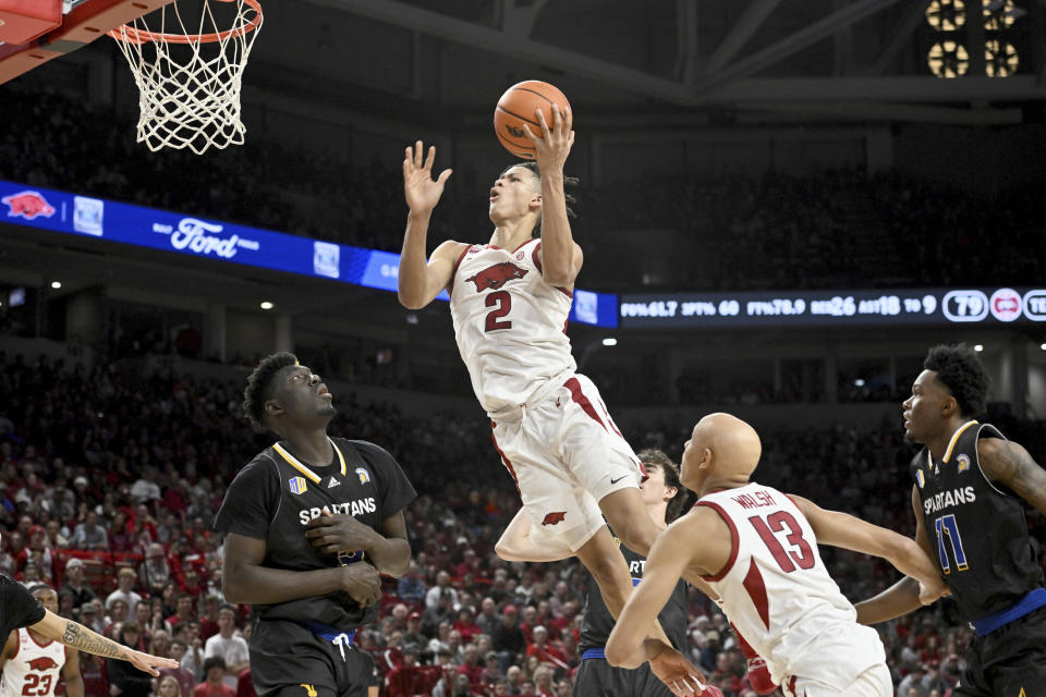 Arkansas forward Trevon Brazile (2) drives past San Jose State center Ibrahima Diallo (left) to score during the second half of an NCAA college basketball game Saturday, Dec. 3, 2022, in Fayetteville, Ark. (AP Photo/Michael Woods)