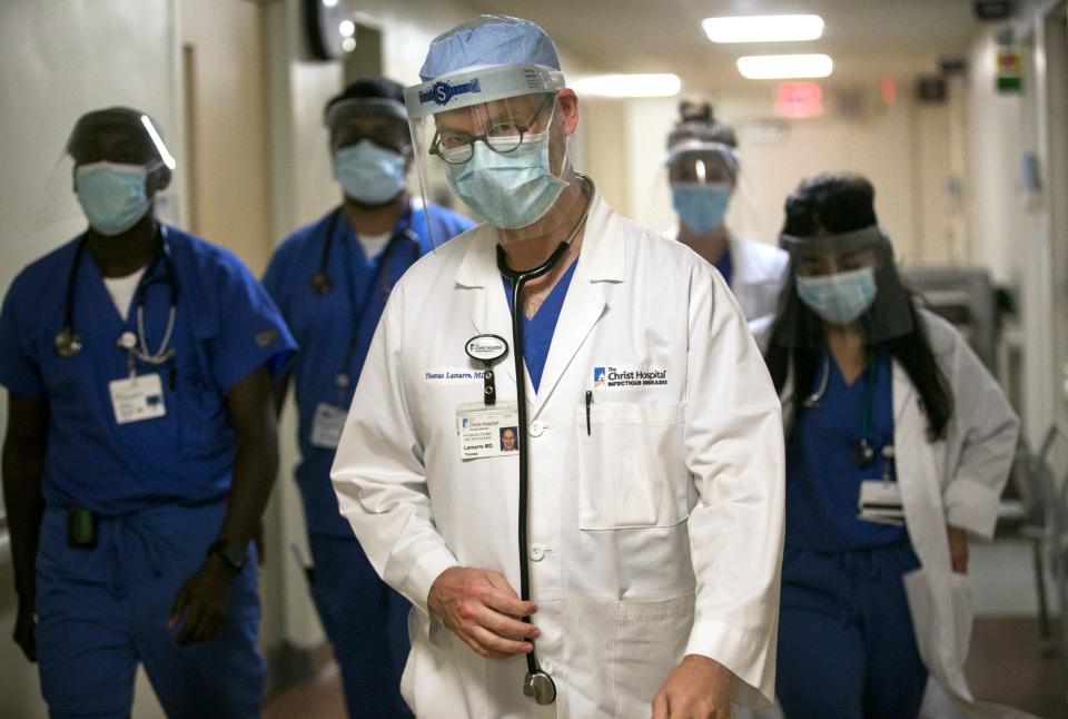 Dr. Thomas Lamarre, head of infectious diseases at the Christ Hospital, conducts rounds with his residents just months into the novel coronavirus pandemic, on Aug. 26, 2020.