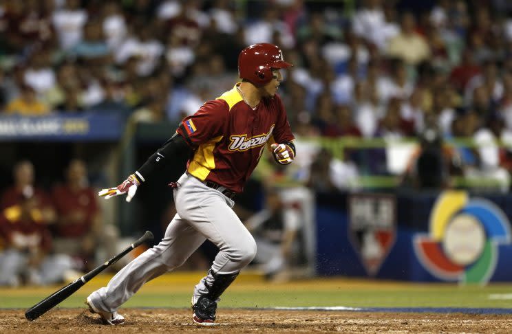 Venezuela's Carlos Gonzalez follows through for a hit during the World Baseball Classic first round game against the Dominican Republic in San Juan, Puerto Rico, Thursday, March 7, 2013. (AP Photo/Andres Leighton)