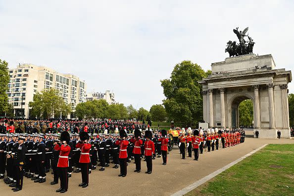 LONDON, ENGLAND - SEPTEMBER 19: The coffin of Queen Elizabeth II with the Imperial State Crown resting on top, borne on the State Gun Carriage of the Royal Navy followed by members of the royal family proceeds past The Wellington Arch on September 19, 2022 in London, England. Elizabeth Alexandra Mary Windsor was born in Bruton Street, Mayfair, London on 21 April 1926. She married Prince Philip in 1947 and ascended the throne of the United Kingdom and Commonwealth on 6 February 1952 after the death of her Father, King George VI. Queen Elizabeth II died at Balmoral Castle in Scotland on September 8, 2022, and is succeeded by her eldest son, King Charles III.  (Photo by David Ramos/Getty Images)