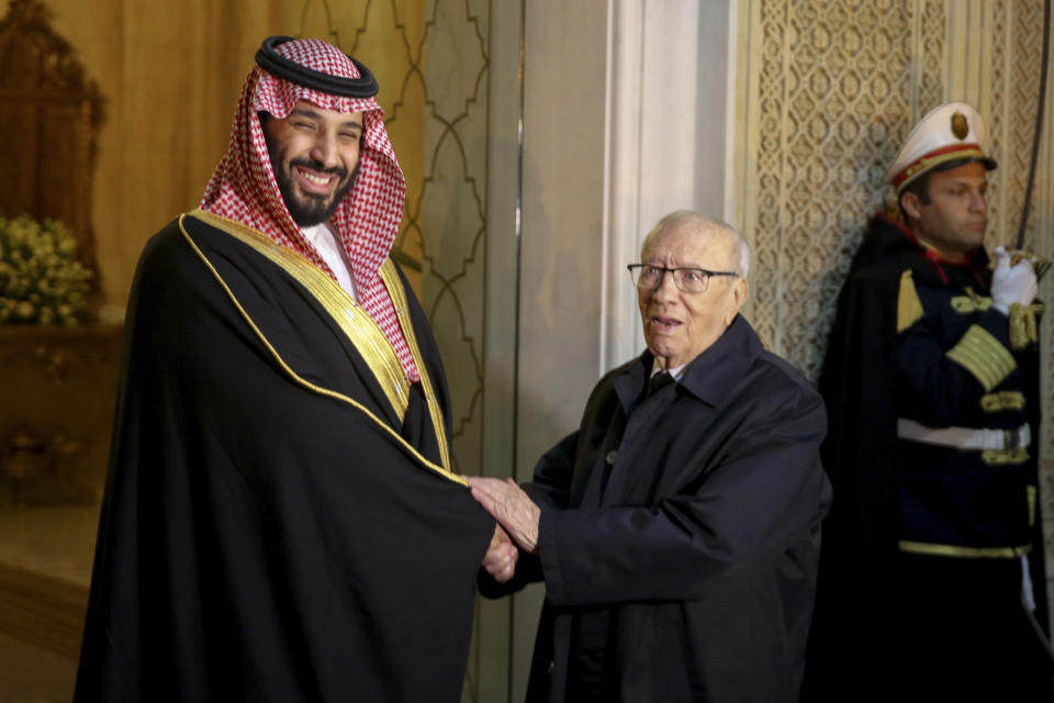 Tunisian President Beji Caid Essebsi, right, shakes hands with Saudi Crown Prince Mohammed bin Salman upon his arrival at the presidential palace in Carthage near Tunis, Tunisia, Tuesday, Nov. 27, 2018. Traveling abroad for the first time since the killing of Saudi journalist Jamal Khashoggi, the crown prince is visiting allies in the Middle East before heading to a G20 summit in Argentina later this week. (AP Photo/Hassene Dridi)