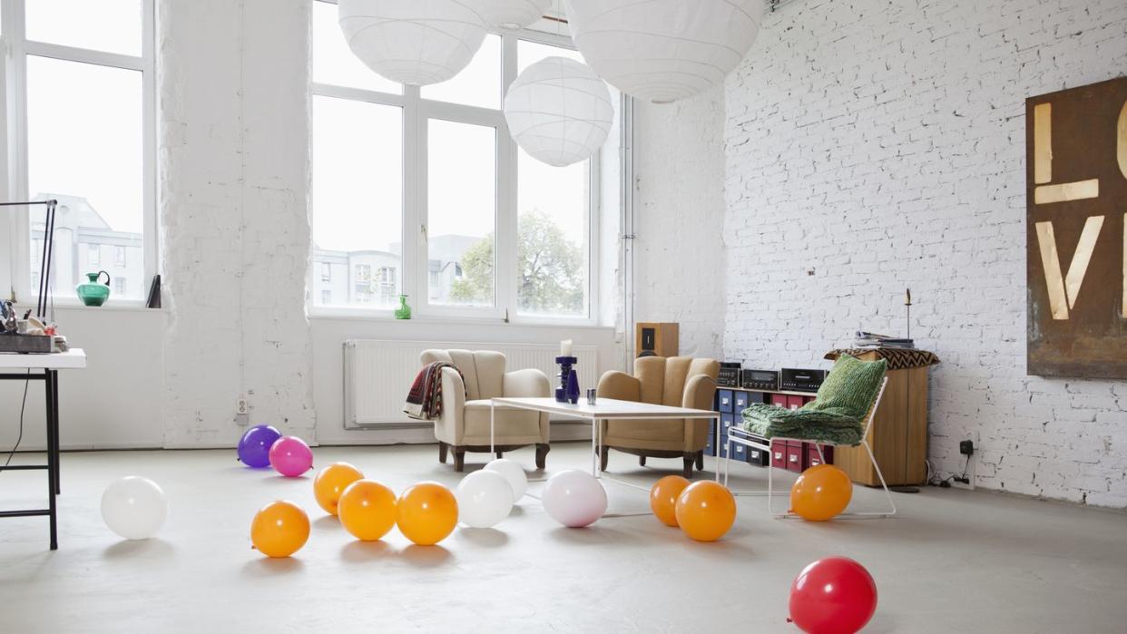 multi colored balloons on the floor of a modern living room