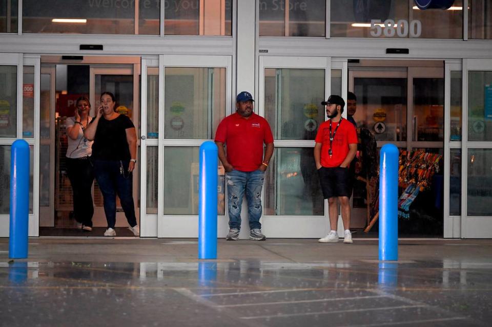 Customers stood in the doorway after a storm bringing heavy rain took the power at the Ross store in Merriam on Friday, July 14, 2023.