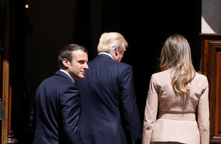 U.S. President Donald Trump and first lady Melania Trump greet French President Emmanuel Macron (L) before a lunch ahead of a NATO Summit in Brussels, Belgium, May 25, 2017. REUTERS/Jonathan Ernst