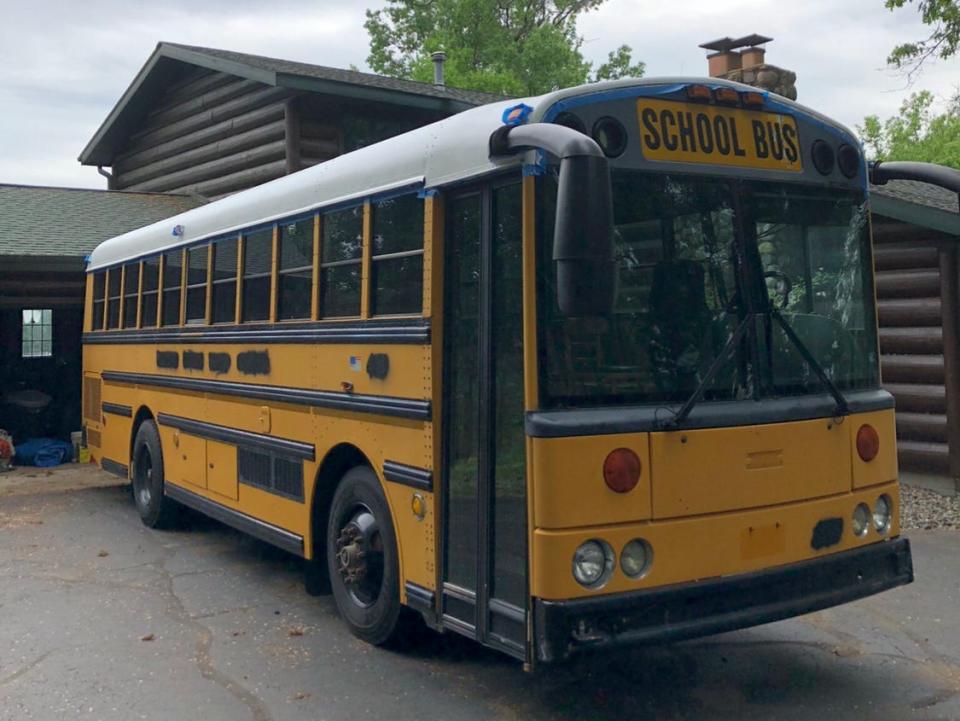 Yellow school bus parked outside of home