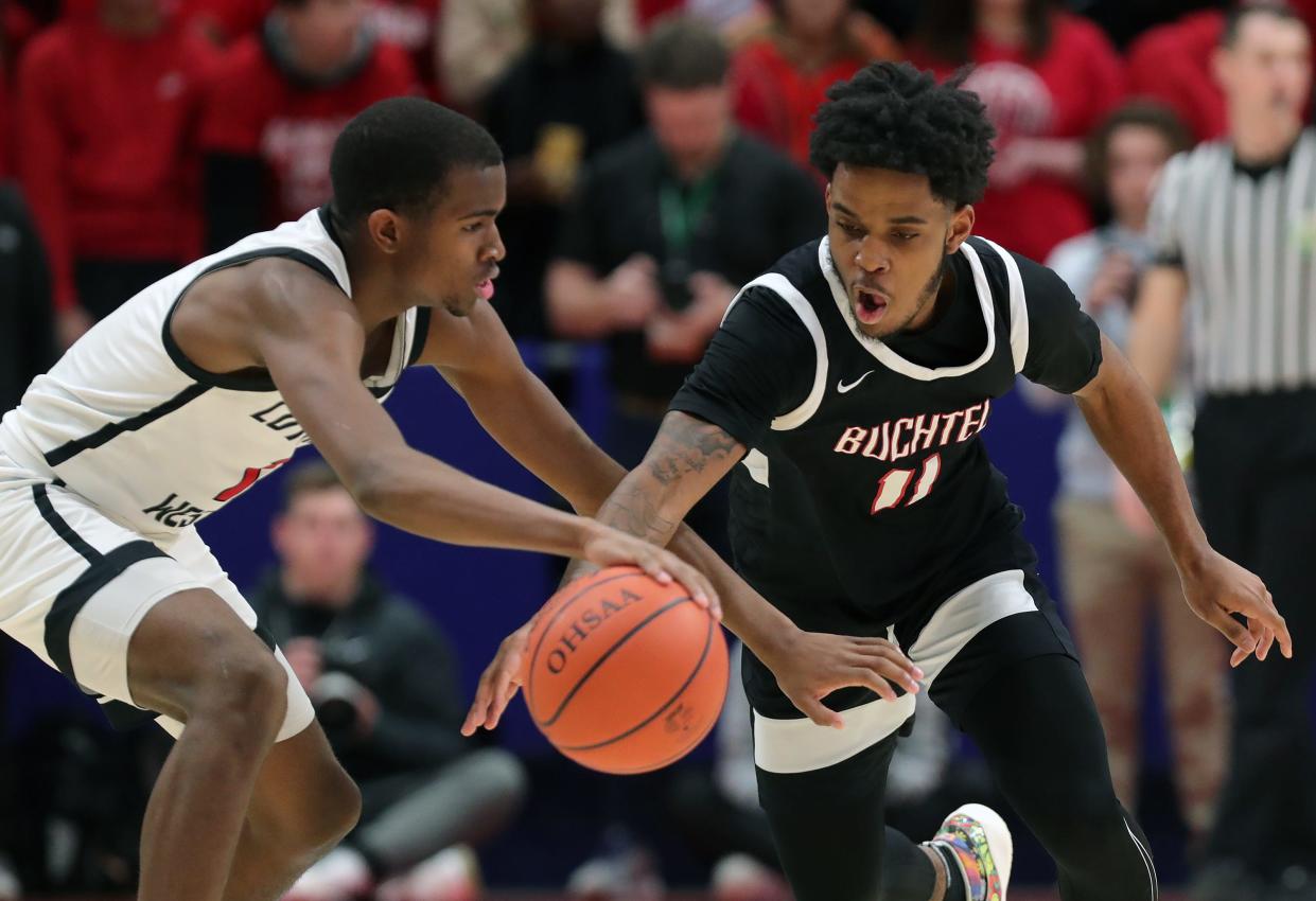 Buchtel guard Marcel Boyce Jr., right, reaches for the ball against Lutheran West guard Derek Fairley during the second half of the OHSAA Division II state championship basketball game at UD Arena, Sunday, March 19, 2023, in Dayton, Ohio.