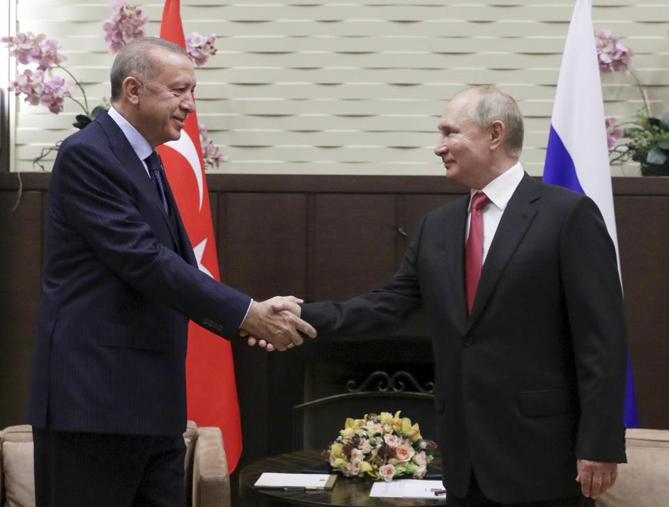 Russian President Vladimir Putin, right, and Turkish President Recep Tayyip Erdogan shake hands during their meeting in the Bocharov Ruchei residence in the Black Sea resort of Sochi, Russia, Wednesday, Sept. 29, 2021. (Vladimir Smirnov, Sputnik, Kremlin Pool Photo via AP)