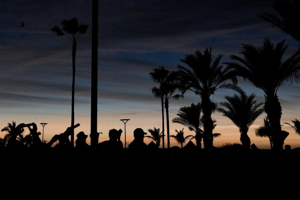 People watch a total solar eclipse as the sky goes dark in Mazatlan, Mexico.<span class="copyright">Fernando Llano—AP</span>