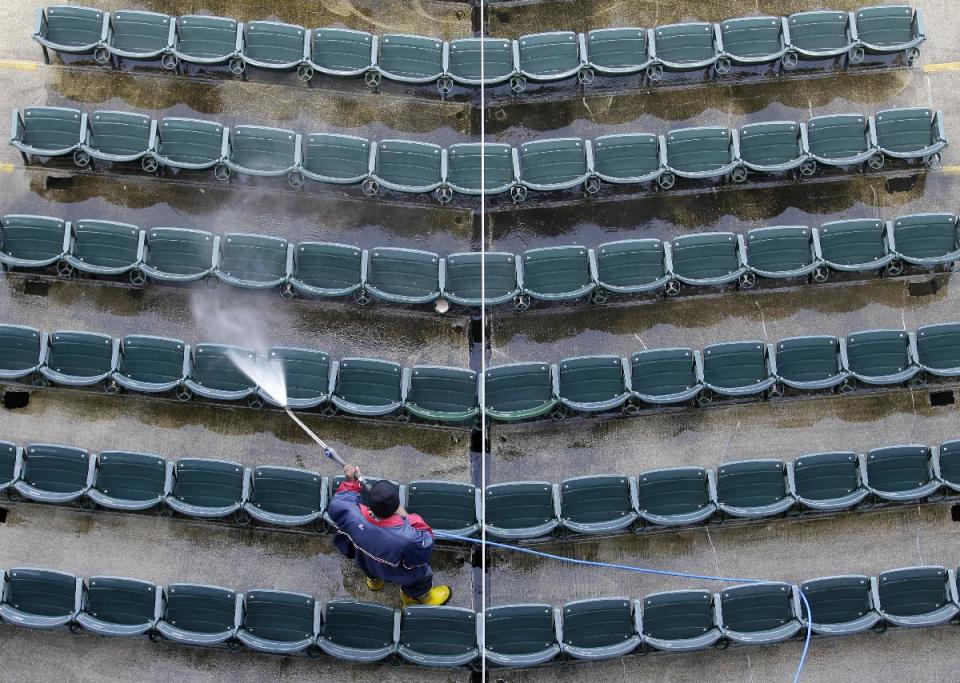 A worker cleans a section of seat at Progressive Field, home of baseball's Cleveland Indians, in Cleveland on Wednesday, March 28, 2012. Opening day for the Indians is April 5. (AP Photo/Amy Sancetta)