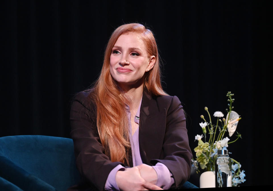 Close-up of Jessica sitting down and smiling