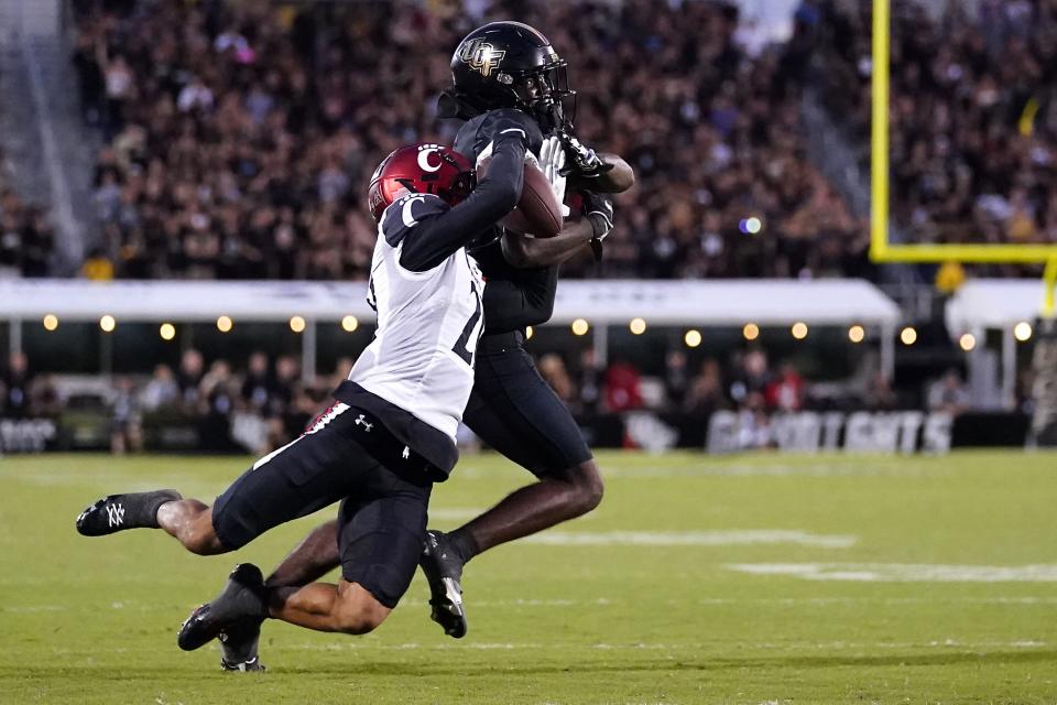 Cincinnati Bearcats wide receiver Tyler Scott (21) is unable to catch a pass as UCF Knights defensive back Justin Hodges (12) in the fourth quarter during a college football game, Saturday, Oct. 29, 2022, at FBC Mortgage Stadium in Orlando, Fla. The UCF Knights defeated the Cincinnati Bearcats, 25-21. 
