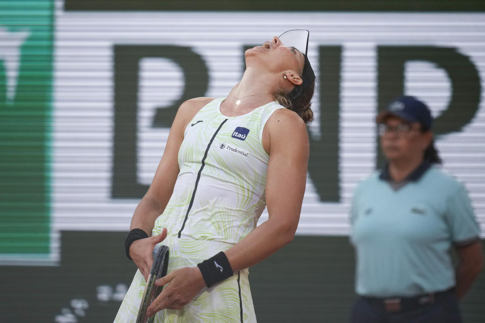 Brazil's Beatriz Haddad Maia reacts after missing a shot against Poland's Iga Swiatek during their semifinal match of the French Open tennis tournament at the Roland Garros stadium in Paris, Thursday, June 8, 2023. (AP Photo/Christophe Ena)