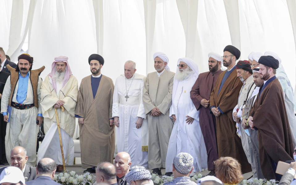 Pope Francis stands with religious leaders during an interreligious meeting near the archaeological area of the Sumerian city-state of Ur, 20 kilometers south-west of Nasiriyah, Iraq, Saturday, March 6, 2021. Ur is considered the traditional birthplace of Abraham, the prophet common to Muslims, Christians and Jews.Francis traveled to the southern ruins of Ur on Saturday to reinforce his message of interreligious tolerance and fraternity during the first-ever papal visit to Iraq, a country riven by religious and ethnic divisions. (AP Photo/Andrew Medichini)