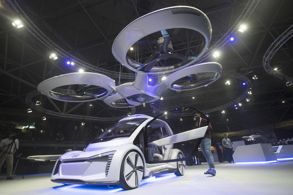 Pop.Up Next, a prototype designed by Audi, Airbus and Italdesign is displayed at the Amsterdam Drone Week in Amsterdam, Netherlands, Tuesday, Nov. 27, 2018. The two-seater vehicle combines combines ground transportation with vertical take-off and landing capabilities. (AP Photo/Peter Dejong)