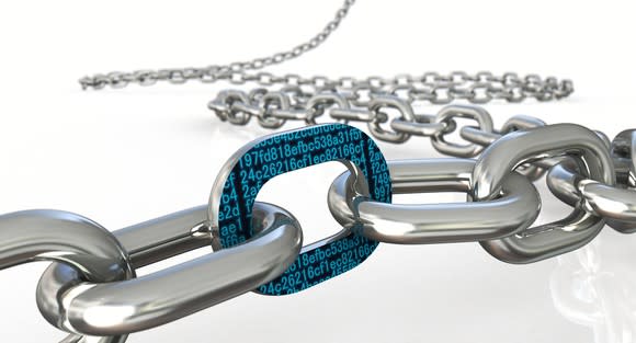 A long steel chain with one link containing cryptographic symbols.