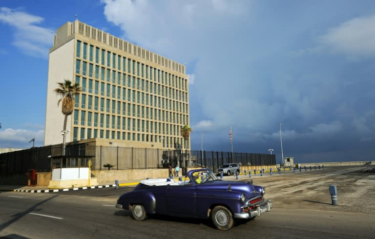 A vintage car drives by the US Embassy in Havana, which Secretary of State Rex Tillerson has said could be closed over alleged sonic attacks on American diplomats