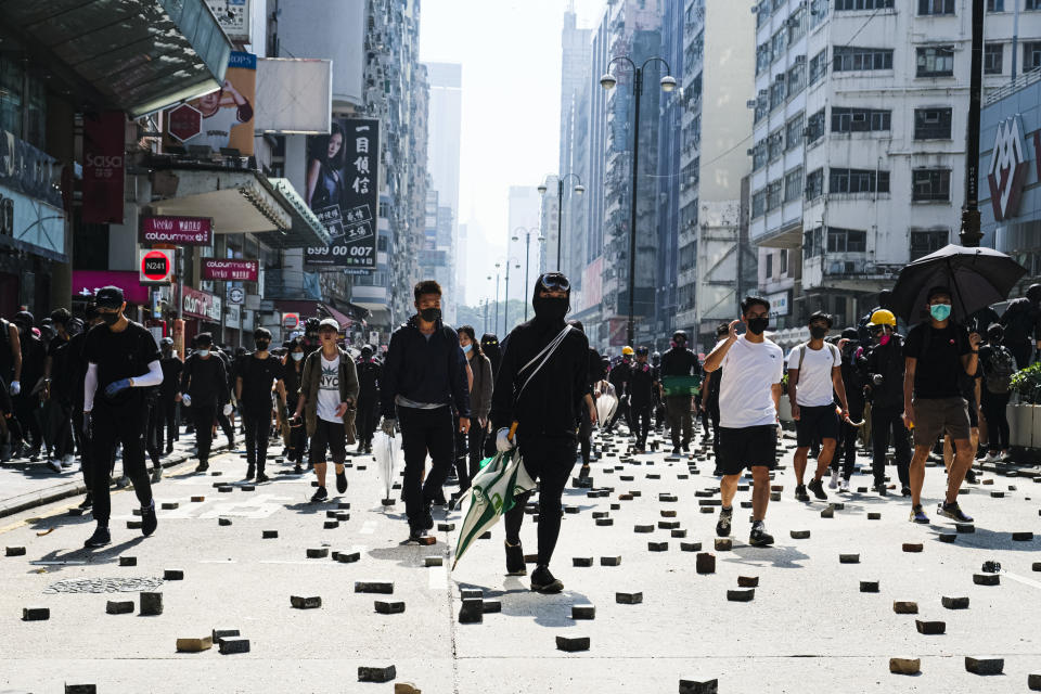 HONG KONG, CHINA - 2019/11/18: Protesters confront the police on Nathan Road during the demonstration. As a standoff continued in Hong Kong, protesters clashed with police near Hong Kong Polytechnic University in Kowloon, leading to multiple arrests and injuries. (Photo by Keith Tsuji/SOPA Images/LightRocket via Getty Images)