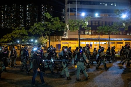 Riot police officers patrol to disperse anti-government protesters during a demonstration near Ma On Shan Police station, Hong Kong