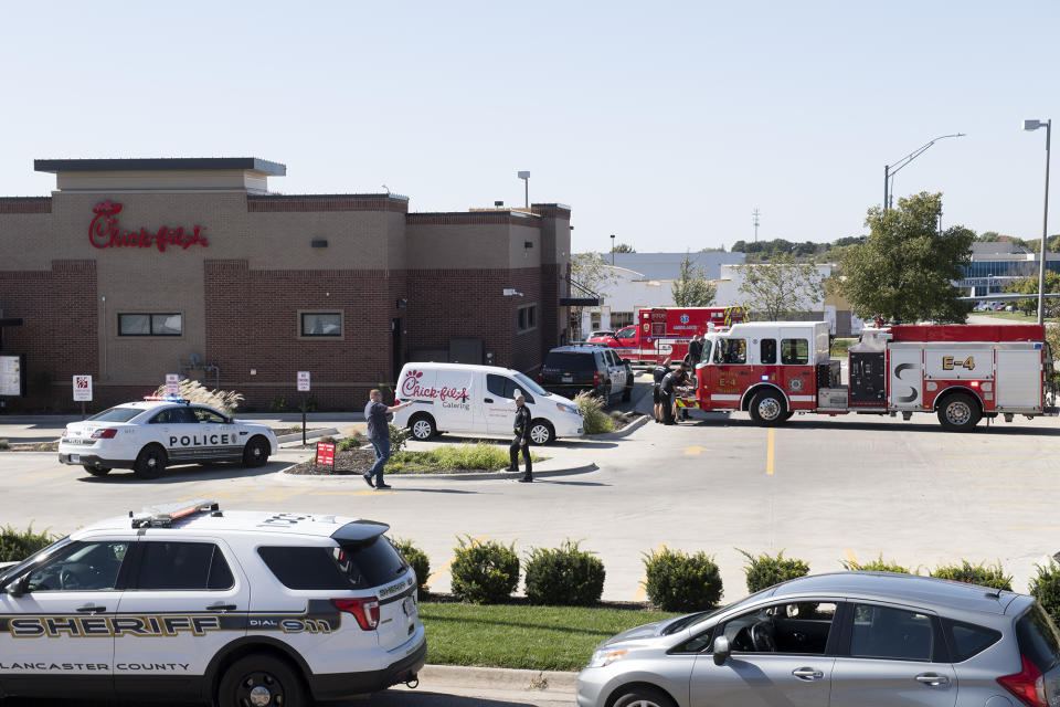 Lincoln Police Department investigates the scene of a shooting at a Chick-fil-A restaurant Tuesday, Oct. 8, 2019 in Lincoln, Neb. A uniformed railroad officer fatally shot a disgruntled customer who rammed his truck into restaurant police said Tuesday. (Gwyneth Roberts/Lincoln Journal Star via AP)