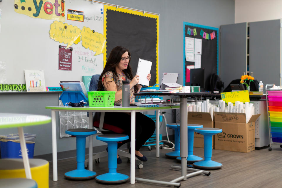 Ruth Harris virtually teaches a third grade class for students who are either at home or in a separate classroom as in-person learning resumes with restrictions in place to prevent the spread of coronavirus disease (COVID-19) at Wilson Primary School in Phoenix, Arizona, U.S., August 17, 2020.  REUTERS/Cheney Orr