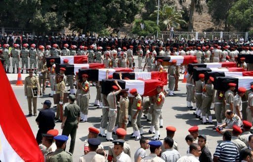 Egyptian military police carry the coffins of 16 soldiers killed in an attack in Sinai during their funeral in Cairo on August 7. Egypt's military killed 20 militants in a helicopter strike in Sinai on Wednesday, state television reported, days after 16 of its soldiers were killed in an attack attributed to Islamic extremists