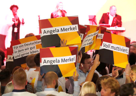 People at the Christian Democratic Union (CDU) headquarters celebrate the CDU's victory in the German general election (Bundestagswahl) in Berlin, Germany, September 24, 2017. REUTERS/Fabrizio Bensch