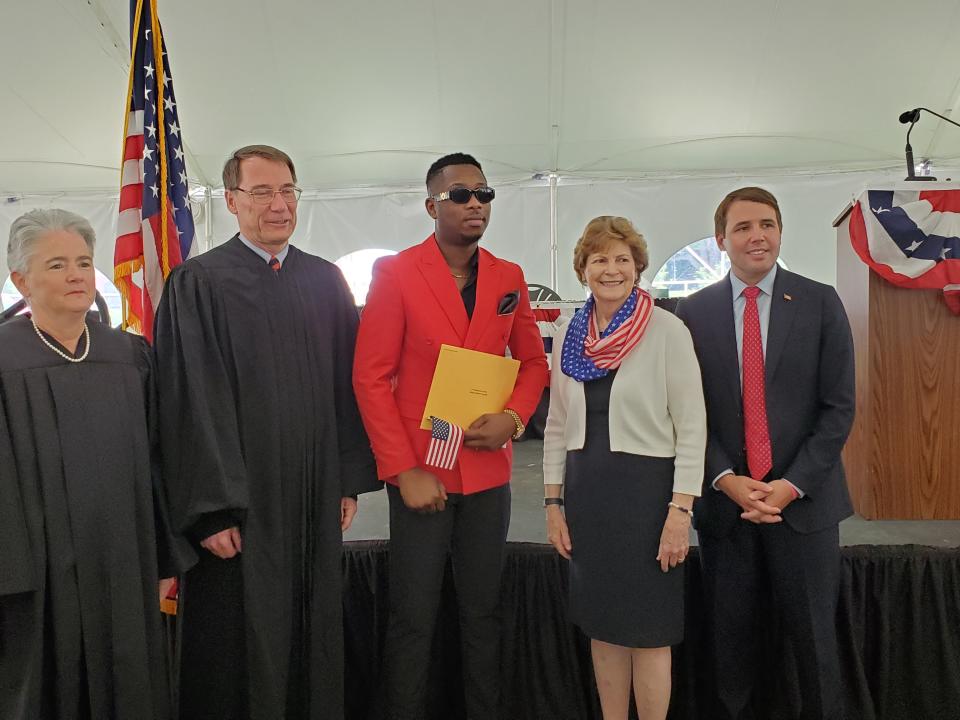 U.S. District Court of New Hampshire Chief Judge Landya B. McCafferty, left, New Hampshire Supreme Court Justice James Bassett, Manchester resident Joe Bagwabi, who came to the U.S. from the Democratic Republic of the Congo, Sen. Jeanne Shaheen and Rep. Chris Pappas take part in a naturalization ceremony Monday, July 4, 2022, at Strawbery Banke Museum in Portsmouth.