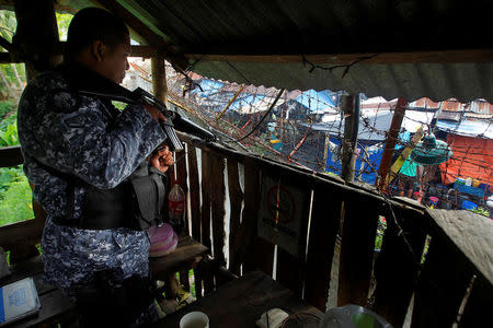 A prison guard stands guard in a watch tower in the prison compound following the escape of more than 150 inmates after gunmen stormed the prison in North Cotabato province, southern Philippines January 4, 2017. REUTERS/Marconi Navales