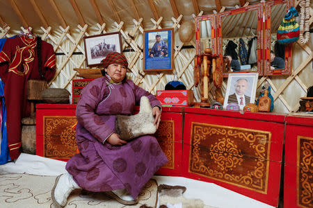 Tanzurun Darisyu, 51, supporter of presidential candidate Vladimir Putin and head of a private farm located in Kara-Charyaa area in the south of Kyzyl town, the administrative centre of the Republic of Tyva (Tuva region), poses for a picture inside her yurt in Southern Siberia, Russia, February 14, 2018. "We, the Arat people, farmers, need to be able to be confident about what tomorrow will look like. We need this in order to expand and develop our farmsteads." said Darisyu. REUTERS/Ilya Naymushin