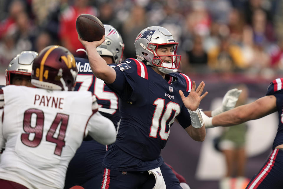 New England Patriots quarterback Mac Jones (10) looks to pass the ball while under pressure from Washington Commanders defensive tackle Daron Payne (94) in the second half of an NFL football game, Sunday, Nov. 5, 2023, in Foxborough, Mass. (AP Photo/Charles Krupa)