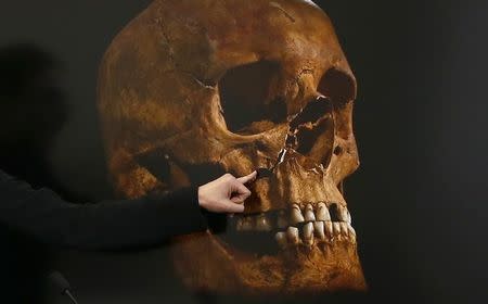 Project Osteologist Jo Appleby is seen pointing out damage to a skull, believed to be that of Richard III, during a news conference in Leicester, central England in this February 4, 2013 file photograph. REUTERS/Darren Staples/Files