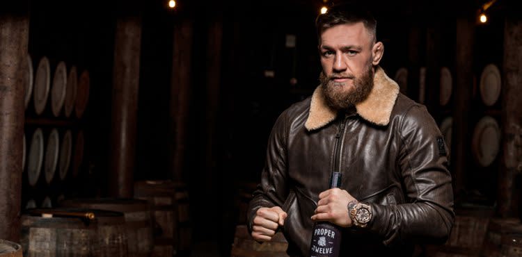 Conor McGregor with bottle of Proper No 12