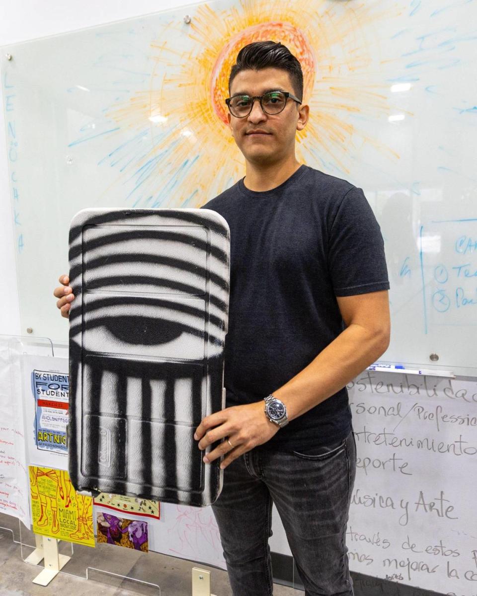 Collector and Little Havana resident Hector Mesa, 37, holds one of his pieces by David Anasagasti, aka Ahol Sniffs Glue.