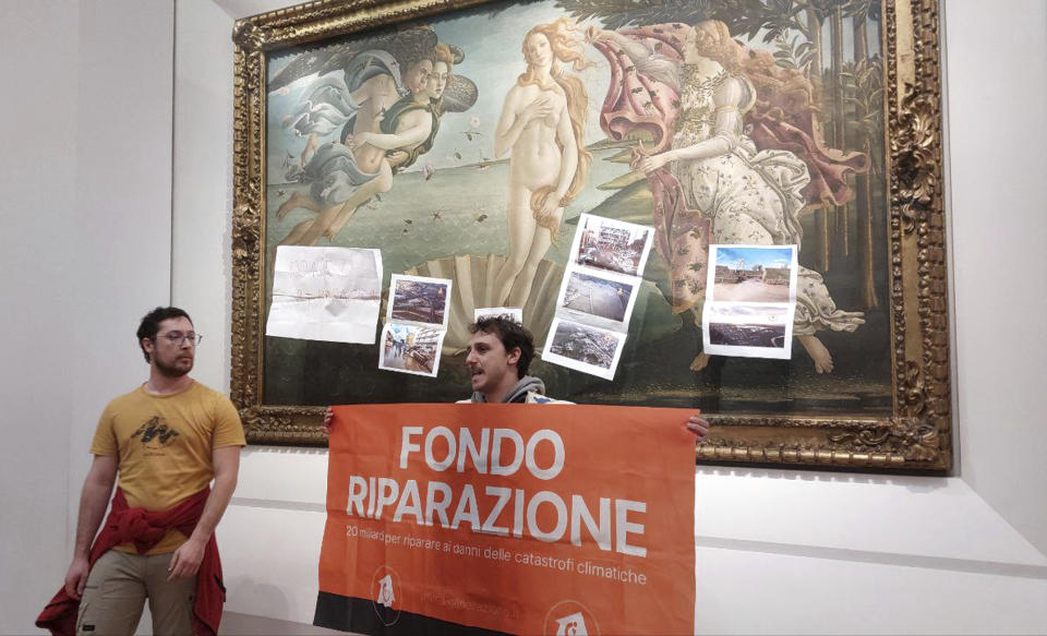 Activists from the Last Generation climate movement protest after attaching materials on the glass protecting Botticelli’s “The Birth of Venus” at Florence’s Uffizi Gallery in Florence, Italy, Tuesday Feb. 13, 2024. Two climate activists on Tuesday targeted Botticelli’s masterpiece “The Birth of Venus” hanging at Florence’s Uffizi Gallery, attaching images of recent flood damage in the Tuscany region on the protective glass. (Emiliano Benedetti, FirenzeToday via AP)